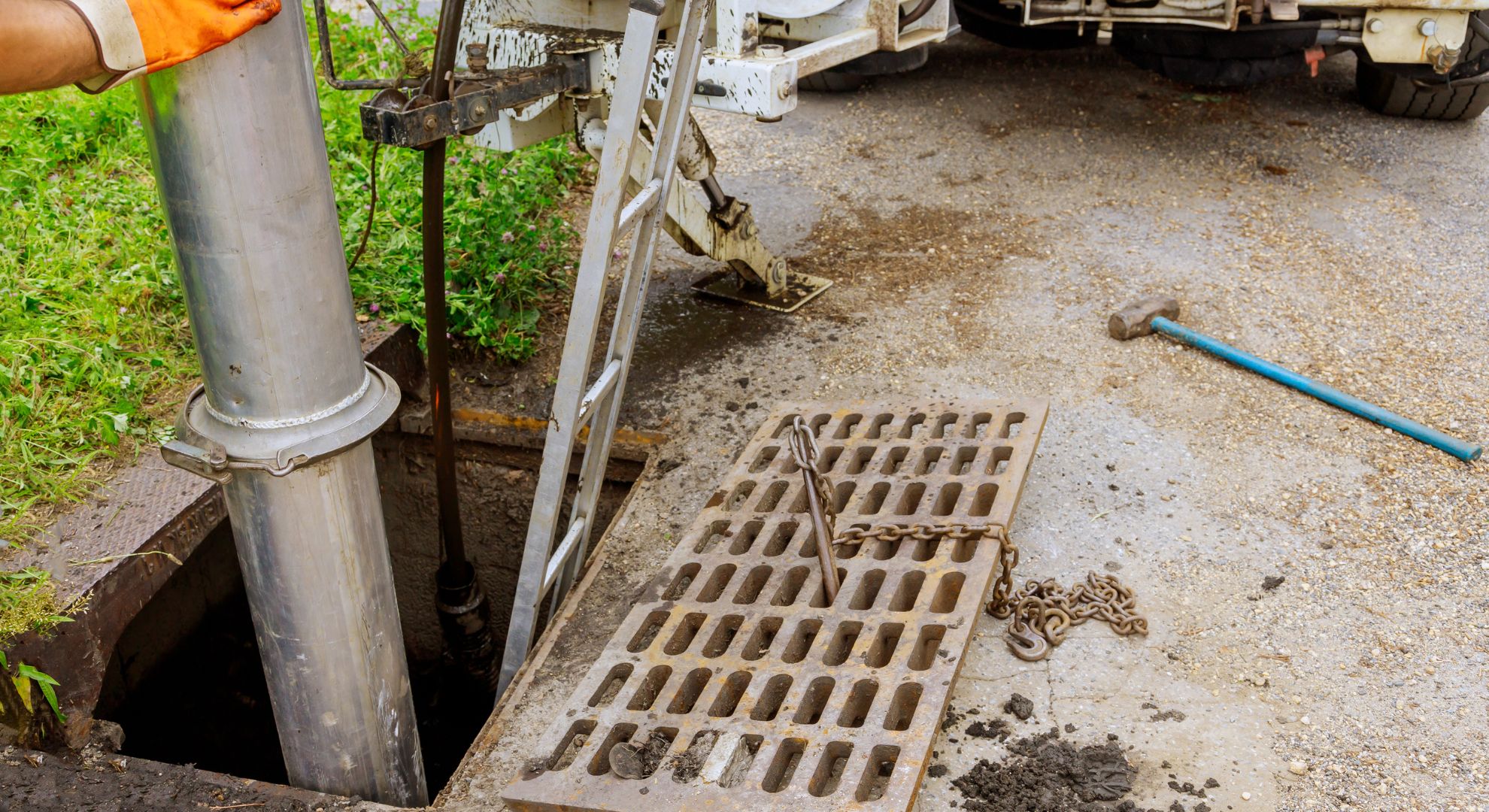 Worker Cleaning a Sewer System